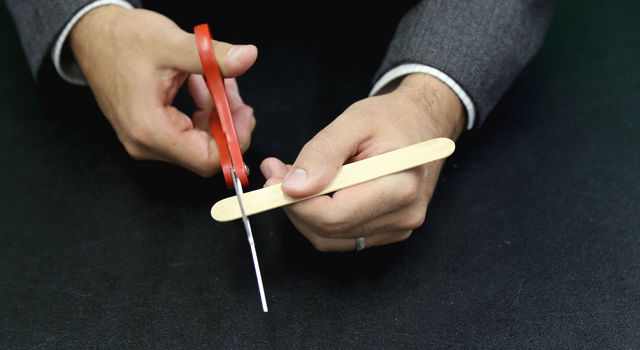 Cutting end of one popsicle stick