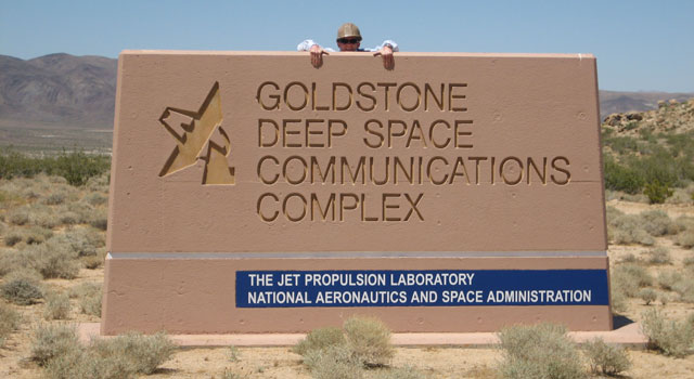 Andrew Crawford looks out over the Goldstone Deep Space Communications Complex sign