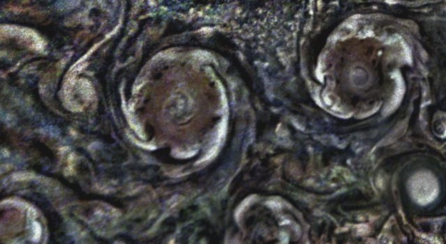 In this animated GIF, the clouds on the periphery of some of Jupiter's polar cyclones rotate counterclockwise, while the core of the cyclones rotate clockwise
