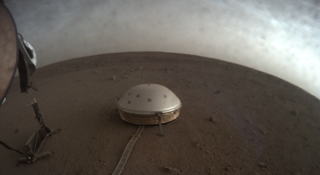 Clouds drift over the dome-covered seismometer, known as SEIS, belonging to NASA's InSight lander, on Mars