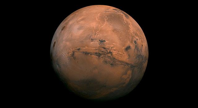 Mars appears in deep orange-red against the black backdrop of space