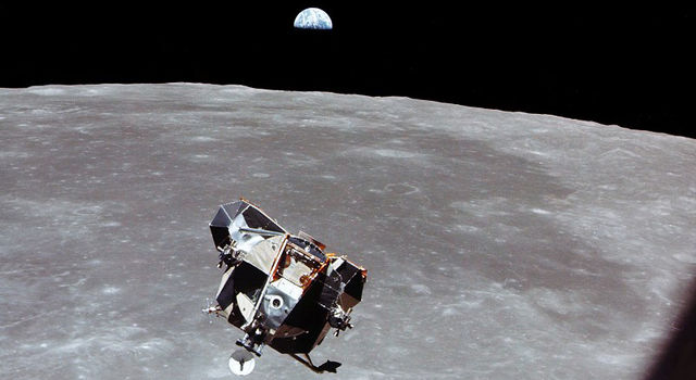 Image of the Apollo 11 lunar module flying above the Moon with the Earth visible in the distance.