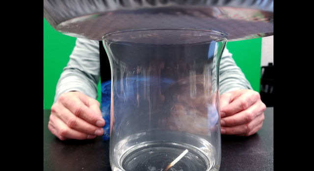 Man Sits On Glass Jar