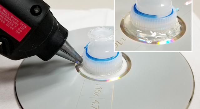 Adding glue between the disk and bottle top