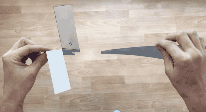 Animated image of a person dropping the paper helicopter at the same time as a piece of paper. The flat paper lands first.