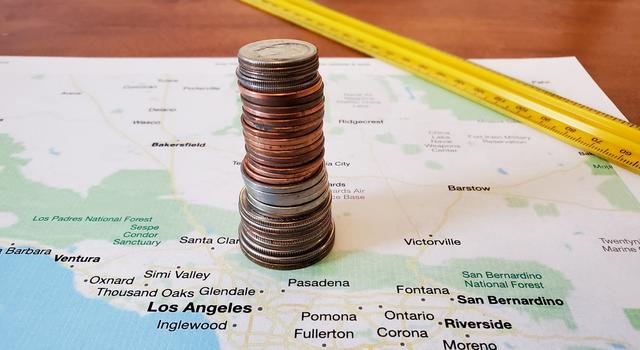 Coins stacked on top of a printed map of the Los Angeles area