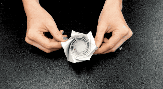 Animated image showing hands opening and closing the starshade origami model