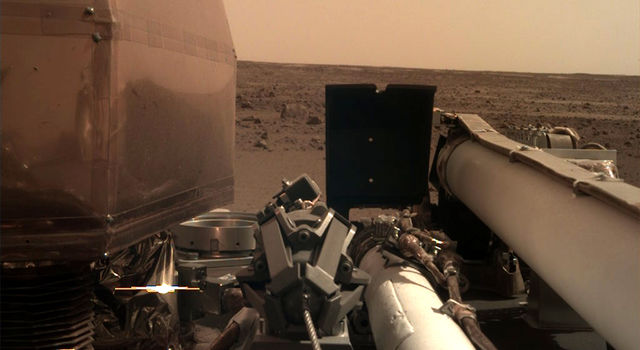 The Instrument Deployment Camera (IDC), located on the robotic arm of NASA's InSight lander, took this picture of the Martian surface on Nov. 26