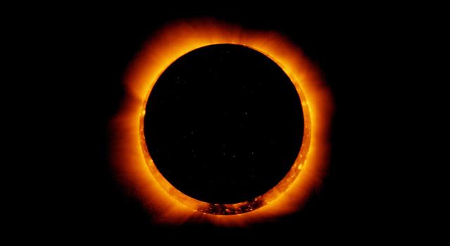 The bubbling surface of the Sun's disk and the surrounding haze of orange and yellow light can be seen as a ring around the blackened disk of the Moon.