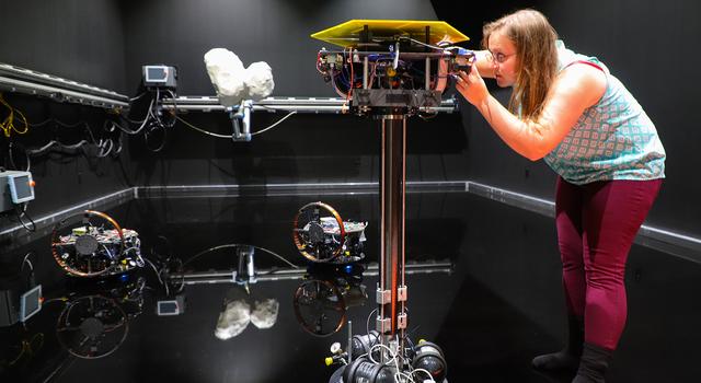 JPL fellow Becca Foust stands in a spacecraft testbed at Caltech. Image credit: Evan Kramer