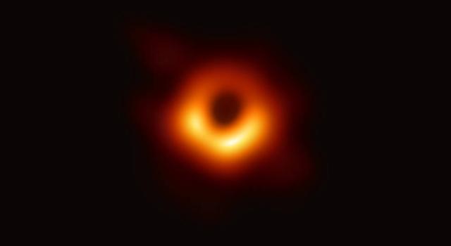 A glowing, orange ring outlines a black hole.