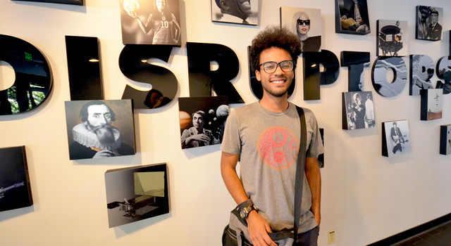 Jarod Boone poses in front of a mural at JPL