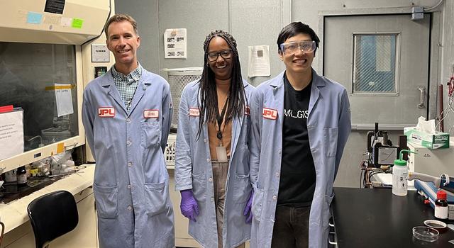 Jones, a caucasian man, stands beside Robinson, a Black woman, and Wang, a man of Asian descent